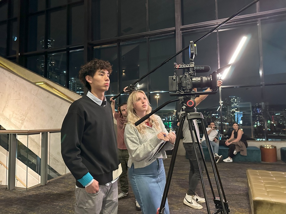Photo of students working on set