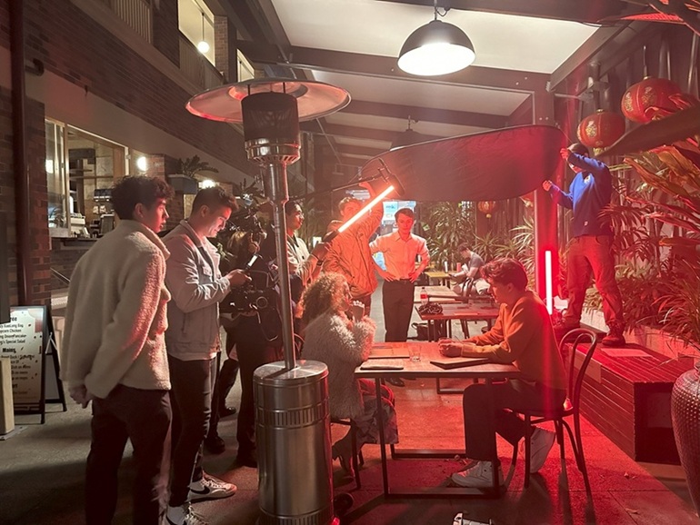Photo of students working on set